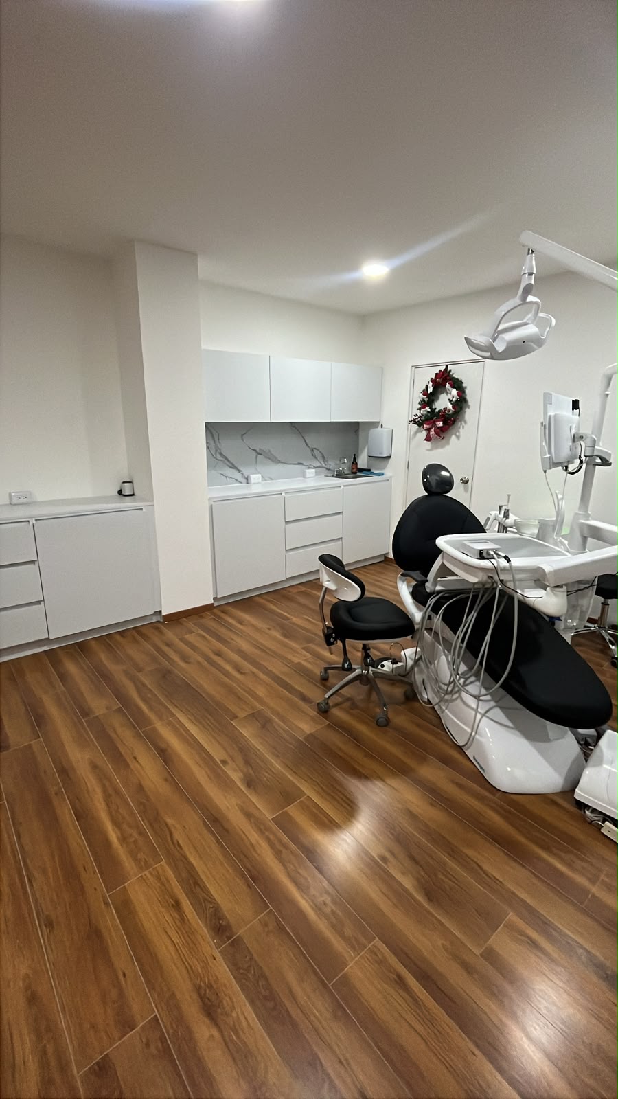 Consultorio dental con mobiliario blanco a la medida y backsplash de mármol